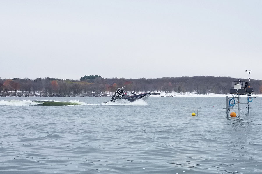 A wakesurf boat in surf mode throwing a large wake on a Minnesota lake, from University of Minnesota St. Anthony Falls Laboratory wake research